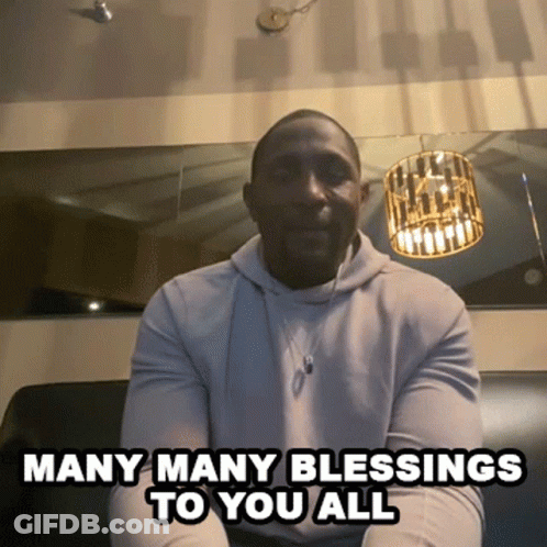 A Man Is Sitting On A Couch With The Words Many Many Blessings To You All GIF