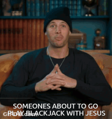 A Man Is Sitting On A Couch With The Words Someones About To Go Play Blackjack With Jesus GIF