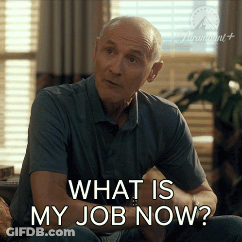A Man Is Sitting On A Couch With The Words What Is My Job Now GIF