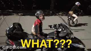 A Man Is Sitting On A Motorcycle With The Words What On The Side GIF