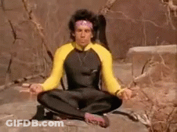 A Man Is Sitting On A Rock In A Lotus Position . GIF