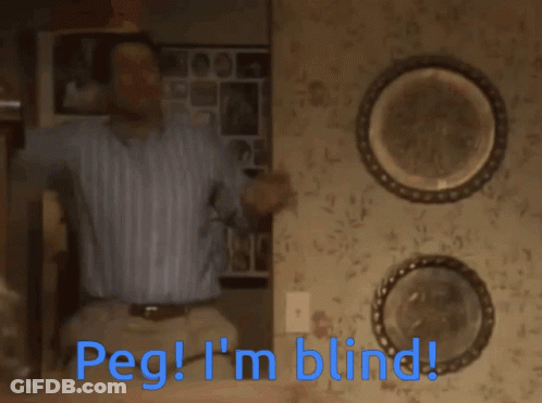 A Man Is Sitting On A Set Of Stairs With The Words Peg I 'M Blind Below Him GIF