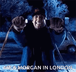 A Man Is Sitting On A Sled In The Snow And Making A Face . GIF