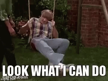A Man Is Sitting On A Swing With The Words `` Look What I Can Do '' Written Below Him . GIF