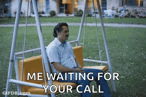 A Man Is Sitting On A Swing With The Words Me Waiting For Your Call Below Him GIF