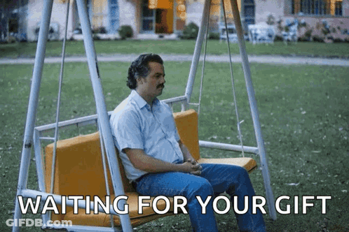 A Man Is Sitting On A Swing With The Words " Waiting For Your Gift " Below Him GIF