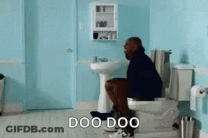 A Man Is Sitting On A Toilet In A Bathroom With The Words `` Doo Doo '' . GIF