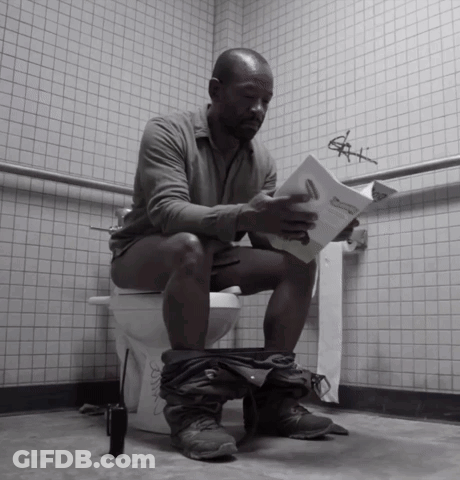A Man Is Sitting On A Toilet Reading A Book Titled " A Man 'S Manual " GIF