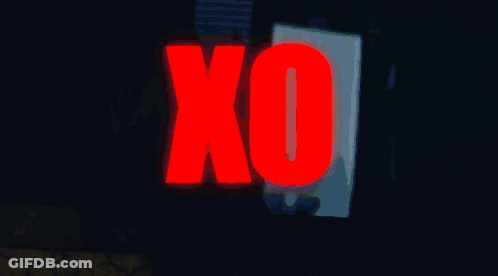 A Man Is Sitting On A Wall With The Word Xo In Red GIF