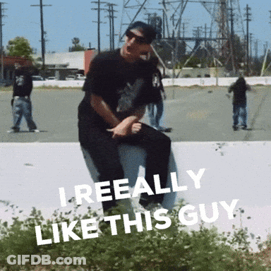 A Man Is Sitting On A Wall With The Words " I Reeally Like This Guy " On The Bottom GIF