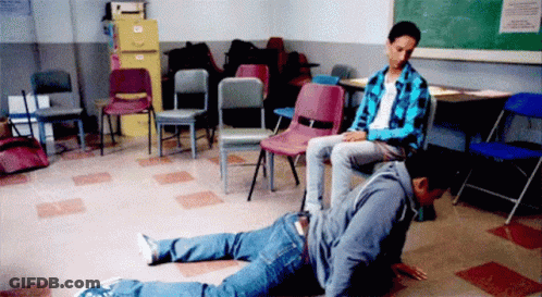 A Man Is Sitting On Another Man 'S Back In A Room With Chairs GIF