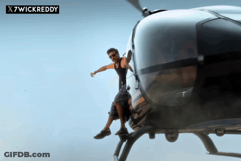 A Man Is Sitting On The Back Of A Helicopter With X7wickreddy Written On The Bottom GIF