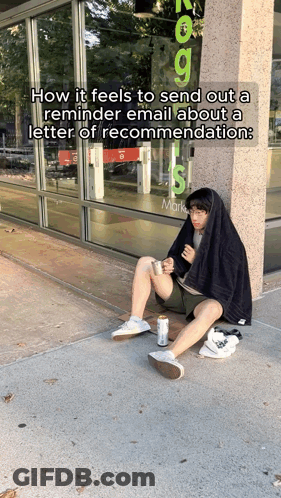 A Man Is Sitting On The Sidewalk In Front Of A Store That Says Marks GIF