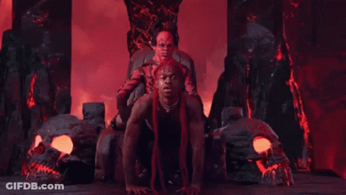 A Man Is Sitting On Top Of Another Man In A Throne In A Video . GIF