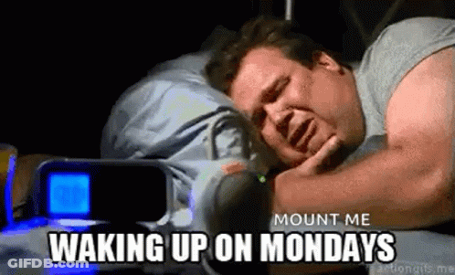 A Man Is Sleeping In A Bed With A Alarm Clock In The Background And The Words `` Mount Me Waking Up On Mondays '' . GIF