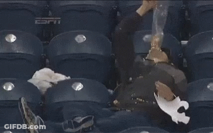A Man Is Sleeping In A Stadium With Espn Written On The Seat GIF