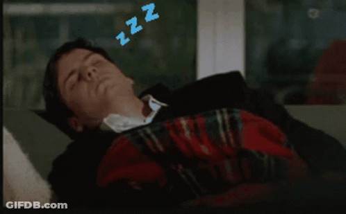 A Man Is Sleeping On A Couch With Zzz Above His Head GIF