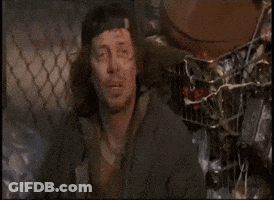 A Man Is Sleeping On A Pile Of Cans GIF