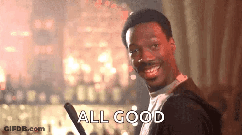 A Man Is Smiling And Holding A Bat And The Words `` All Good '' Are Written On The Screen . GIF