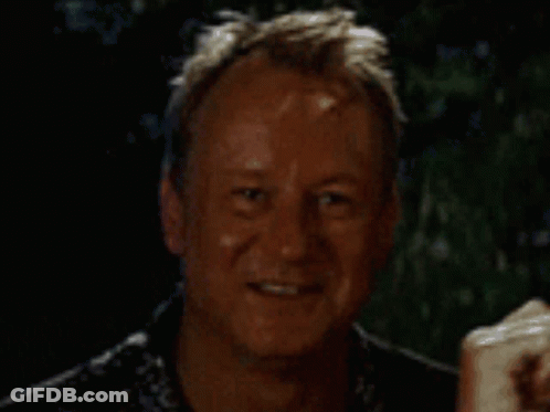 A Man Is Smiling And Holding A Piece Of Paper GIF