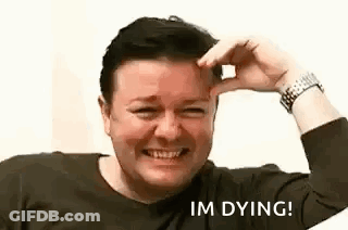 A Man Is Smiling And Holding His Hand To His Forehead While Making A Funny Face . GIF
