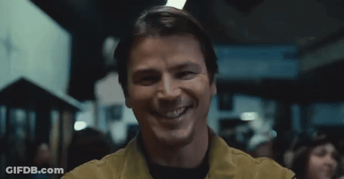 A Man Is Smiling And Looking At The Camera In A Blurry Photo . GIF