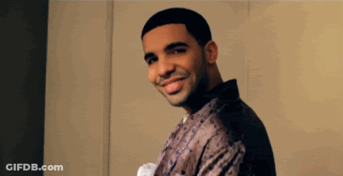 A Man Is Smiling And Looking At The Camera While Wearing A Robe . GIF
