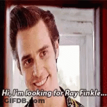 A Man Is Smiling And Looking For Ray Finkle . GIF
