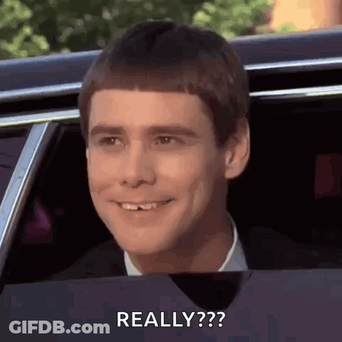 A Man Is Smiling And Looking Out Of A Car Window With The Words `` Really '' Written On The Bottom . GIF