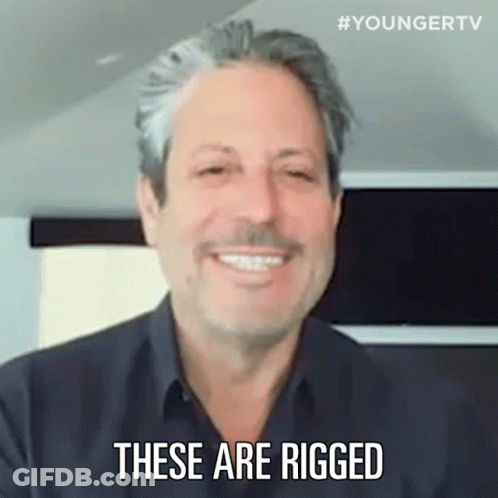 A Man Is Smiling And Saying `` These Are Rigged '' . GIF