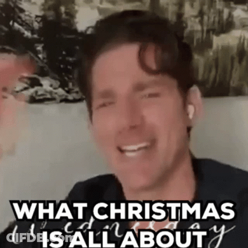 A Man Is Smiling And Saying `` What Christmas Is All About '' While Sitting On A Couch . GIF