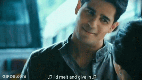 A Man Is Smiling And Talking To A Woman While Holding A Microphone . GIF