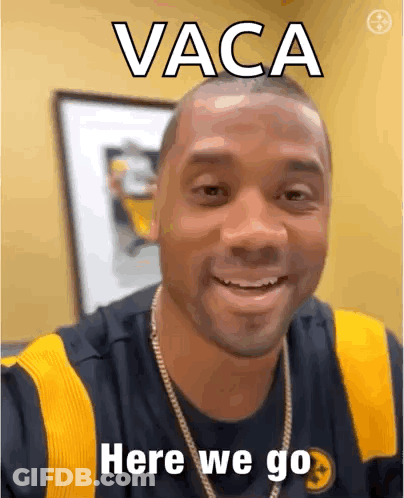 A Man Is Smiling And Wearing A Black And Yellow Shirt With The Words Vaca Here We Go Written On It . GIF