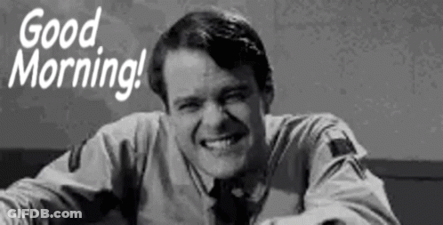 A Man Is Smiling In A Black And White Photo With The Words `` Good Morning '' . GIF