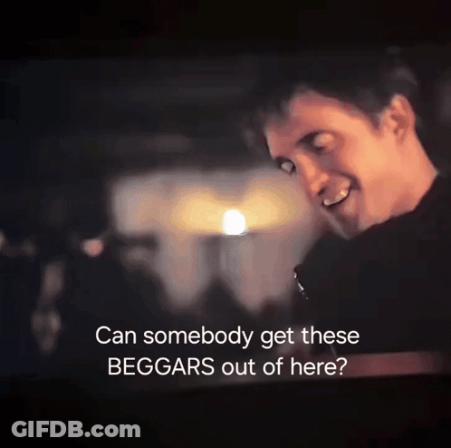 A Man Is Smiling In A Dark Room With The Words " Can Somebody Get These Beggars Out Of Here " GIF
