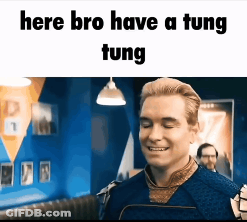 A Man Is Smiling In A Room With The Words Here Bro Have A Tung Tung GIF