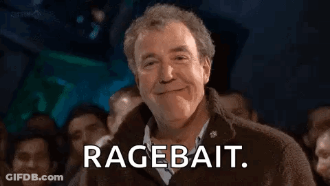 A Man Is Smiling In Front Of A Crowd Of People And Saying `` Ragebait '' . GIF