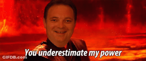A Man Is Smiling In Front Of A Red Background With The Words You Underestimate My Power GIF