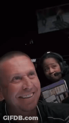 A Man Is Smiling In Front Of A Sign That Says Ufc 300 . GIF