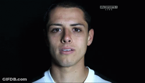 A Man Is Smiling In Front Of A Sky Sports Live Sign GIF