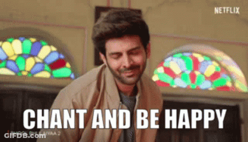 A Man Is Smiling In Front Of A Stained Glass Window And Says Chant And Be Happy GIF
