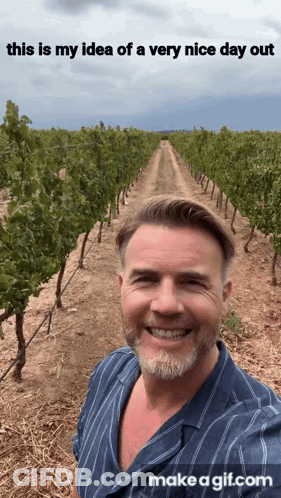 A Man Is Smiling In Front Of A Vineyard With The Words " This Is My Idea Of A Very Nice Day Out " Above Him GIF