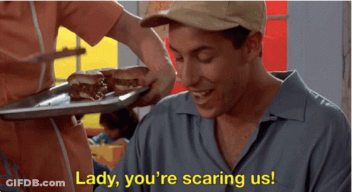 A Man Is Smiling While A Woman Holds A Tray Of Food And Says Lady You 'Re Scaring Us .. GIF