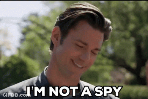 A Man Is Smiling While Saying `` I 'M Not A Spy '' . GIF