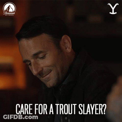 A Man Is Smiling With The Words Care For A Trout Slayer Above Him GIF