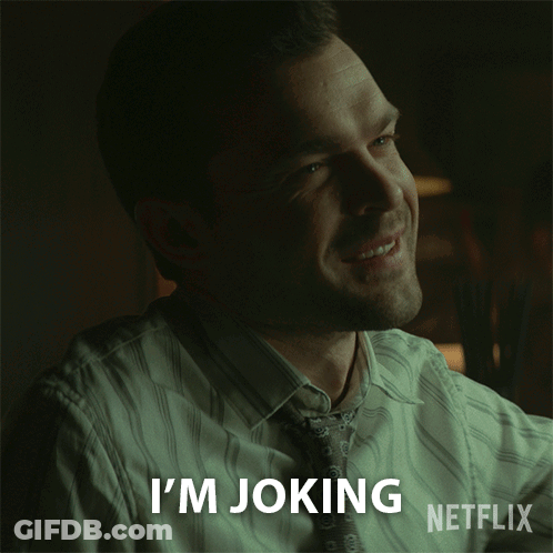 A Man Is Smiling With The Words I 'M Joking Netflix Behind Him GIF