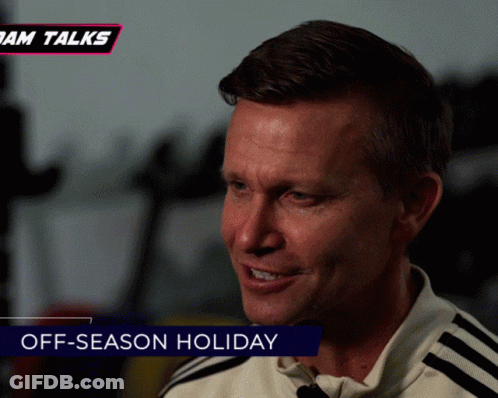 A Man Is Smiling With The Words Off-Season Holiday Behind Him GIF