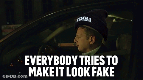 A Man Is Smoking A Cigar While Driving A Car With The Words Everybody Tries To Make It Look Fake . GIF
