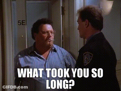 A Man Is Smoking A Cigarette And Talking To A Police Officer In A Doorway . GIF