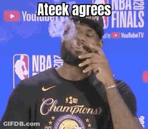 A Man Is Smoking A Cigarette In Front Of A Basketball Player Wearing A Championship Shirt . GIF